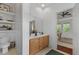 Bright bathroom featuring a wooden vanity with a white countertop and a connecting bedroom at 1726 Waterbrook Dr, Charleston, SC 29414