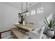 Dining room with modern chandelier, wood table, and an abundance of natural light at 1726 Waterbrook Dr, Charleston, SC 29414