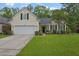 Charming single-Gathering home with a well-manicured lawn and attached two-car garage at 1726 Waterbrook Dr, Charleston, SC 29414