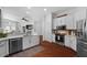 Bright kitchen features stainless appliances, stone countertops, white cabinets, and wood flooring at 1726 Waterbrook Dr, Charleston, SC 29414