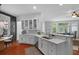 Open kitchen boasts white cabinets, stone countertops, stainless appliances and a serving bar overlooking the Gathering room at 1726 Waterbrook Dr, Charleston, SC 29414