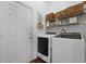 Functional laundry room with modern washer and dryer and ample storage shelving at 1726 Waterbrook Dr, Charleston, SC 29414
