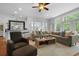 Bright, open living room with large windows, stylish furniture, and an adjacent bar area at 1726 Waterbrook Dr, Charleston, SC 29414
