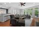 Spacious living room with a large sectional sofa, hardwood floors, and natural light from the windows at 1726 Waterbrook Dr, Charleston, SC 29414