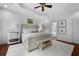 Bright bedroom features a tray ceiling, neutral decor, and a cozy sitting bench at 1726 Waterbrook Dr, Charleston, SC 29414