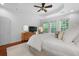 Sunlit bedroom boasts tray ceilings, and soft natural light with a dresser with a TV on top at 1726 Waterbrook Dr, Charleston, SC 29414