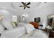 Spacious bedroom offers soft lighting, ceiling fan, and adjoining bathroom at 1726 Waterbrook Dr, Charleston, SC 29414