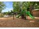 Community playground with climbing structure and slides in a secure, fenced-in area at 1726 Waterbrook Dr, Charleston, SC 29414