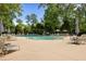 Resort-style community pool with chairs, umbrellas, and lounge area, perfect for relaxation at 1726 Waterbrook Dr, Charleston, SC 29414