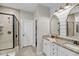 Well-lit bathroom with a double vanity, granite countertop, and a tiled walk-in shower at 1814 Grovehurst Dr, Charleston, SC 29414