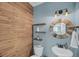 Stylish bathroom with rustic wood accents, modern fixtures, and a unique round mirror at 1814 Grovehurst Dr, Charleston, SC 29414