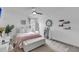 Cozy bedroom featuring a comfortable bed with a plush pink throw, modern fan, and bright natural light at 1814 Grovehurst Dr, Charleston, SC 29414
