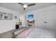 Bright bedroom featuring a comfortable bed, modern fan, a flatscreen TV, desk, and double closets at 1814 Grovehurst Dr, Charleston, SC 29414