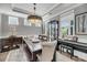 Elegant dining room with a large wooden table, decorative lighting, and ample natural light at 1814 Grovehurst Dr, Charleston, SC 29414