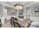 Open-concept dining room with a large wooden table and views of the kitchen at 1814 Grovehurst Dr, Charleston, SC 29414