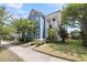 Charming two-story blue home featuring a welcoming front porch and well-manicured landscaping at 1814 Grovehurst Dr, Charleston, SC 29414