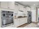 Bright kitchen featuring stainless steel appliances, granite countertops, and white cabinetry at 1814 Grovehurst Dr, Charleston, SC 29414