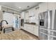 Open kitchen with stainless steel appliances, granite countertops, and stylish sliding barn door at 1814 Grovehurst Dr, Charleston, SC 29414
