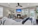 Comfortable living room with a fireplace, ceiling fan, and large windows at 1814 Grovehurst Dr, Charleston, SC 29414