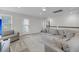 Spacious living area featuring a cozy sectional sofa, area rug, and natural light from the windows and doors at 1814 Grovehurst Dr, Charleston, SC 29414