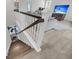 Bright living room featuring a plush sofa, TV, and staircase with wooden steps and white railings at 1814 Grovehurst Dr, Charleston, SC 29414