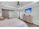 Tranquil primary bedroom features a large bed, dresser, tray ceiling, and barn door access to other areas at 1814 Grovehurst Dr, Charleston, SC 29414