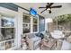 Cozy screened patio with comfortable seating, a ceiling fan, and outdoor decor at 1814 Grovehurst Dr, Charleston, SC 29414