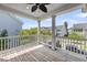 Inviting porch with wood floors, white railing and posts, offering neighborhood views at 1814 Grovehurst Dr, Charleston, SC 29414