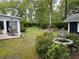 Private backyard with a stone fountain, patio off the sunroom and view of a detached storage shed at 206 Brailsford Rd, Summerville, SC 29485
