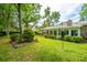 A verdant backyard presents a well-maintained lawn with mature trees and shrubs at 206 Brailsford Rd, Summerville, SC 29485
