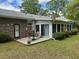 Patio area outside of the sunroom overlooking the lush and private backyard space at 206 Brailsford Rd, Summerville, SC 29485