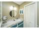 Well-lit bathroom with a round mirror and custom storage cabinets at 206 Brailsford Rd, Summerville, SC 29485