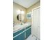 Well-lit bathroom with a round mirror and custom storage cabinets at 206 Brailsford Rd, Summerville, SC 29485