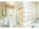 Bright bathroom featuring a glass block accent wall and ample natural light from the window at 206 Brailsford Rd, Summerville, SC 29485