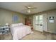 Comfortable bedroom featuring neutral colors, a ceiling fan, and ample natural light from the large window at 206 Brailsford Rd, Summerville, SC 29485
