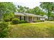 Traditional brick home with a covered porch, black shutters, and a manicured lawn at 206 Brailsford Rd, Summerville, SC 29485