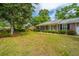 The brick home features a covered porch, manicured lawn, and inviting curb appeal at 206 Brailsford Rd, Summerville, SC 29485
