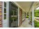 Covered front porch showcases brick accents, pillars, and view of the neighborhood at 206 Brailsford Rd, Summerville, SC 29485