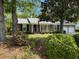 Charming brick home featuring a well-manicured front yard with mature trees and a two-car garage at 206 Brailsford Rd, Summerville, SC 29485