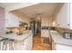 The kitchen features white cabinetry, stainless steel appliances, and a view into the breakfast nook at 206 Brailsford Rd, Summerville, SC 29485