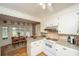 The kitchen features white cabinets and a view into the breakfast nook at 206 Brailsford Rd, Summerville, SC 29485