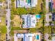 Aerial view showcasing home's layout in a residential area, with swimming pools and tree-lined streets at 2114 Pettigrew St, Sullivans Island, SC 29482