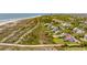 Aerial view showing a community of homes, some with pools, located near the ocean and a boardwalk at 2114 Pettigrew St, Sullivans Island, SC 29482