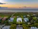 Prime aerial view of a home near the beach, surrounded by lush greenery at 2114 Pettigrew St, Sullivans Island, SC 29482