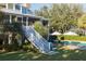 Beautiful backyard with a white staircase, lush lawn, pool, and outdoor seating area at 2114 Pettigrew St, Sullivans Island, SC 29482