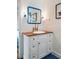 Bathroom with a white vanity, a wooden countertop, and blue tiling at 2114 Pettigrew St, Sullivans Island, SC 29482
