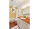 Bright bathroom featuring a yellow-tiled shower, hardwood floors, and modern white vanity at 2114 Pettigrew St, Sullivans Island, SC 29482