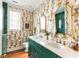 This bathroom features a double vanity, beautiful wallpaper, and modern finishes at 2114 Pettigrew St, Sullivans Island, SC 29482