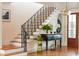 Staircase with hardwood steps and railing, alongside stylish console table and artistic decor at 2114 Pettigrew St, Sullivans Island, SC 29482