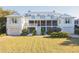 Beautiful home with a garage, lots of green space, and an outdoor living area above at 2114 Pettigrew St, Sullivans Island, SC 29482